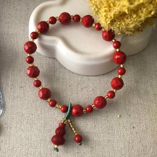 7 mm Red Crater Cut Cinnabar Bead Bracelet with Carved Gourd Charm